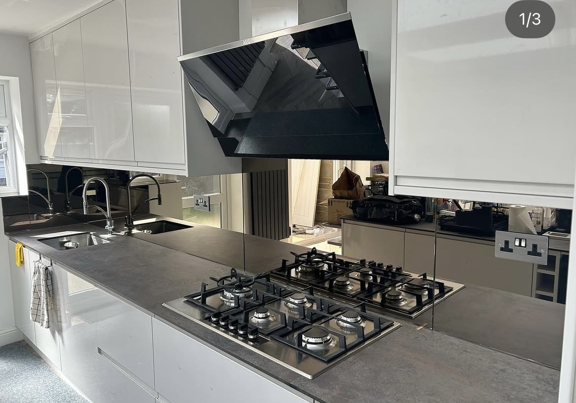 Mirrored glass splashback fitted in a kitchen
